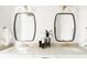 Elegant bathroom with dual sinks, stone countertop, sleek mirrors, and modern fixtures at 1016 28Th St, Denver, CO 80205