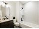 Bathroom with tub and shower, with a dark vanity and black fixtures at 1016 28Th St, Denver, CO 80205