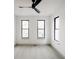 Bright bedroom with three windows and light gray carpeting at 1016 28Th St, Denver, CO 80205