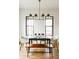 Sunlit dining area features modern lighting and a glass table, creating a bright and inviting atmosphere at 1016 28Th St, Denver, CO 80205