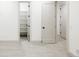 Hallway area with neutral carpet, a view to a shelved storage area, and white doors at 1016 28Th St, Denver, CO 80205