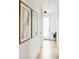 Bright hallway with white walls and light hard wood flooring at 1016 28Th St, Denver, CO 80205