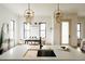 Open-concept kitchen with an island bar with sink and view of dining area with stylish pendant lighting at 1016 28Th St, Denver, CO 80205