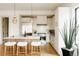 Bright kitchen features white cabinetry, stainless steel appliances, a center island, and pendant lighting at 1016 28Th St, Denver, CO 80205