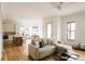 Bright, open-concept living area with hardwood floors, lots of natural light, kitchen, and dining area at 1016 28Th St, Denver, CO 80205