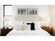 Comfortable main bedroom featuring stylish lamps and a plush bed with decorative pillows at 1016 28Th St, Denver, CO 80205