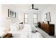 Bright main bedroom with a neutral color scheme, ceiling fan and two windows for natural light at 1016 28Th St, Denver, CO 80205