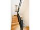 Modern staircase features wood steps, black metal railings, and an abstract painting on the wall at 1016 28Th St, Denver, CO 80205