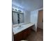 Bathroom sink featuring ample counter space, storage, and a well-lit mirror for convenience at 14852 E Kentucky Dr # 934, Aurora, CO 80012