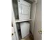 Compact laundry closet with stacked washer and dryer, maximizing space and efficiency for laundry needs at 14852 E Kentucky Dr # 934, Aurora, CO 80012
