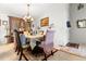 Elegant dining room with chandelier, formal seating, and natural light at 9567 Brentwood Way # A, Broomfield, CO 80021