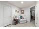 Cozy hallway with a white armchair, side table, and a decorative mirror adding warmth to the interior at 9567 Brentwood Way # A, Broomfield, CO 80021