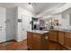 Bright kitchen with a center island, stainless steel refrigerator, and an open doorway at 9567 Brentwood Way # A, Broomfield, CO 80021