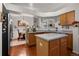 Charming kitchen with stainless steel appliances, wood floors, and a center island at 9567 Brentwood Way # A, Broomfield, CO 80021