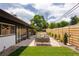 Spacious backyard features a stone patio, lush lawn, and modern wood fencing at 3605 W Berry Ave, Littleton, CO 80123