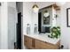 Modern bathroom with white countertops, stylish lighting, and glass shower in a neutral palette at 3605 W Berry Ave, Littleton, CO 80123