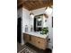 Bright bathroom with a modern wood vanity, white countertop, and trendy pendant lighting at 3605 W Berry Ave, Littleton, CO 80123