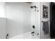 Stylish bathroom featuring a glass-enclosed shower with light-colored tiling and modern fixtures at 3605 W Berry Ave, Littleton, CO 80123
