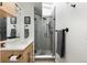 Stylish bathroom featuring a glass-enclosed shower with gray tiling and modern fixtures at 3605 W Berry Ave, Littleton, CO 80123