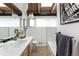 Modern bathroom with wood vanity, above-counter sinks, and trendy pendant lights at 3605 W Berry Ave, Littleton, CO 80123