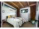 Cozy bedroom with wood ceilings, a patterned bedspread, and ample natural light at 3605 W Berry Ave, Littleton, CO 80123