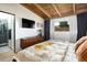 Tastefully decorated bedroom with ensuite bathroom view, wood accents, and a large window providing natural light at 3605 W Berry Ave, Littleton, CO 80123