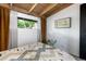 Bedroom with wood ceilings, stylish curtains, and a view of the outdoors at 3605 W Berry Ave, Littleton, CO 80123