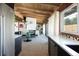 Open-concept dining area with wood-beam ceilings and stylish furniture seamlessly connects to the living spaces at 3605 W Berry Ave, Littleton, CO 80123