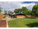 Landscaped backyard with large grassy area, modern patio, and architectural home exterior at 3605 W Berry Ave, Littleton, CO 80123