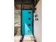 A bright turquoise front door with square windows adds a pop of color and modern flair at 3605 W Berry Ave, Littleton, CO 80123