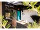 Close up of front entrance featuring a bold turquoise door and unique desert landscaping at 3605 W Berry Ave, Littleton, CO 80123