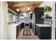 Modern kitchen with black cabinets, white countertops, stainless steel appliances, and eye-catching backsplash at 3605 W Berry Ave, Littleton, CO 80123