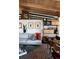 Bright living room showcasing the open floor plan, wood beam ceiling, and modern decor at 3605 W Berry Ave, Littleton, CO 80123