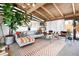 Bright living room showcasing the open floor plan, wood beam ceiling, and modern decor at 3605 W Berry Ave, Littleton, CO 80123
