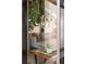 View through glass into living room with exposed beam ceiling, modern decor, and plants at 3605 W Berry Ave, Littleton, CO 80123