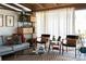 Bright living room showcasing the open floor plan, wood beam ceiling, and neutral decor at 3605 W Berry Ave, Littleton, CO 80123