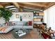 Bright living room showcasing the open floor plan, wood beam ceiling, and neutral decor at 3605 W Berry Ave, Littleton, CO 80123