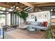 Bright living room featuring an open floor plan with a patterned rug and wood beam ceiling at 3605 W Berry Ave, Littleton, CO 80123