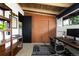 Functional office space with wood shelving, sliding closet doors, and a sleek desk at 3605 W Berry Ave, Littleton, CO 80123