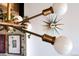 Close up of a mid-century modern-inspired starburst clock and mid-century modern decor at 3605 W Berry Ave, Littleton, CO 80123