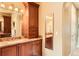 Elegant bathroom with granite countertops, double sinks, and a large mirror at 9850 Sunset Hill Circle Cir, Lone Tree, CO 80124