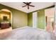 Spacious bedroom with green walls, ceiling fan, and plush carpeting at 9850 Sunset Hill Circle Cir, Lone Tree, CO 80124