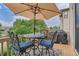 Private deck with table, chairs, umbrella, and grill at 9850 Sunset Hill Circle Cir, Lone Tree, CO 80124