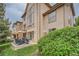 Tan house exterior with large windows and patio at 9850 Sunset Hill Circle Cir, Lone Tree, CO 80124