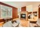 Cozy living room featuring a stone fireplace and hardwood floors at 9850 Sunset Hill Circle Cir, Lone Tree, CO 80124