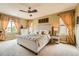 Spacious main bedroom with large windows, ceiling fan, and plush carpet at 9850 Sunset Hill Circle Cir, Lone Tree, CO 80124