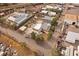 Image shows a yellow home near commercial buildings, salvage yard and train tracks as seen from directly above at 5182 Thompson Ct, Denver, CO 80216