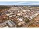 From above, a home and neighborhood appears small next to commercial buildings, auto salvage and downtown Denver at 5182 Thompson Ct, Denver, CO 80216