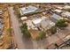 An aerial view of a yellow home with a detached garage and other assorted buildings and parked cars nearby at 5182 Thompson Ct, Denver, CO 80216
