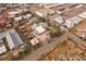 Bird's eye view of home with detached garage situated next to train tracks, salvage yard, and commercial businesses at 5182 Thompson Ct, Denver, CO 80216